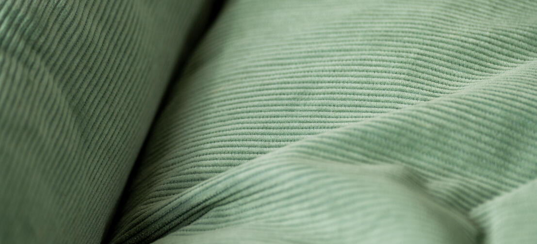 Close up of corduroy texture on corduroy moss nest dog bed.