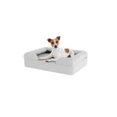 Dog sitting on small stone grey memory foam bolster dog bed