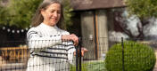 Woman opening chicken netting door