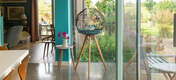 Omlet Geo bird cage with black cage, teal blue and tall legs