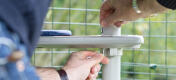 Man attaching the platform accessory to the pole to create a personalised outdoor cat tree