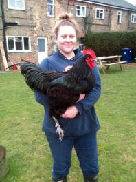 A woman holding prize cockrel!