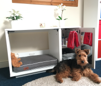 A brown and black dog with a Fido niche and wardrobe attached