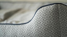 Detail of a nest bed showing honeycomb slate print and bed piping