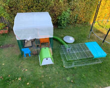 Omlet green Eglu Go rabbit hutch connected to Omlet walk in rabbit run and Omlet Zippi tunnel connected to run