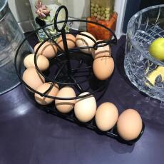 A black egg helter skelter with lots of fresh eggs on it