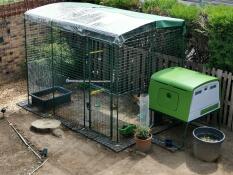 An Eglu chicken coop and wir with transparent cover on the top.