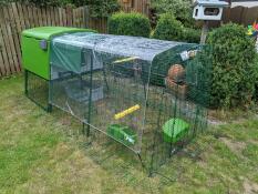 An Omlet chicken coop with a large run cover.
