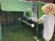 Omlet green Eglu Cube large chicken coop and run with girl