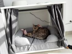 Maya Nook with a bolster bed inside with a cat napping on it