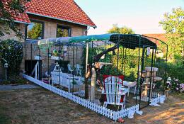 A very large walk in run set up as a catio for cats with lots of toys and accessories