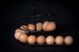 Eggs on a black circular egg skelter