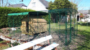 Wooden chicken coop in Omlet walk in chicken run