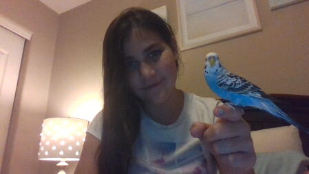 Girl holding parakeet