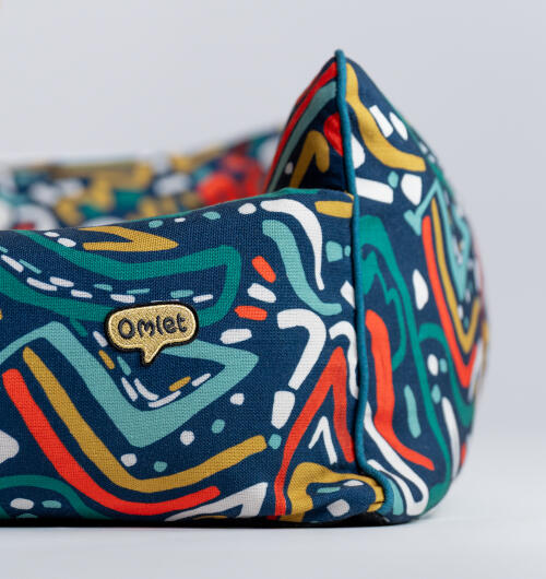 Close up of the nest dog bed in zoomies print