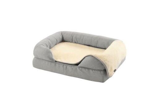 A grey memory foam bolster bed size small 24 with a plush blanket on top