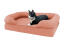 A cat sitting on a pink cat bed. A cat sitting on a pink cat bed.