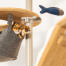 Cat sitting in hammock of Omlet floor to ceiling cat tree playing with fish toy Cat sitting in hammock of Omlet floor to ceiling cat tree playing with fish toy