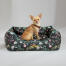 Chihuahua sitting in an Omlet nest bed in the midnight meadow pattern Chihuahua sitting in an Omlet nest bed in the midnight meadow pattern