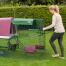 Woman moving Eglu Go up chicken coop with wheels and run handles