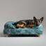 A german shepherd resting in the nature trail bolster dog bed