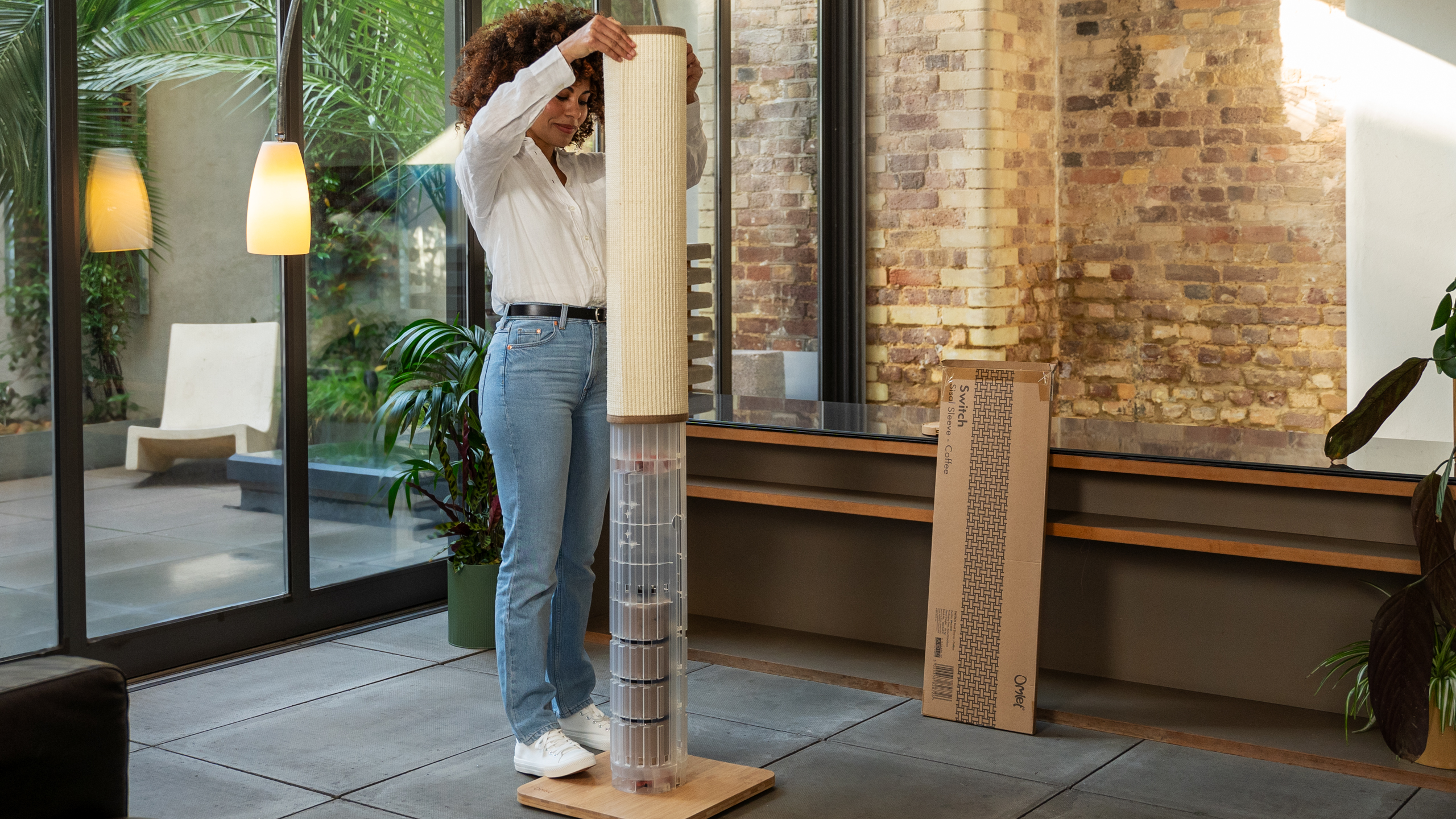 Woman setting up the Switch Cat Scratcher