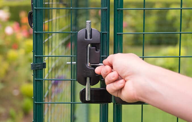 woman locking the safe walk in chicken run