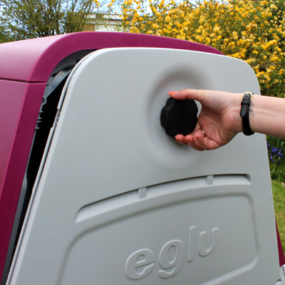 Opening the back door of an Eglu Go House.