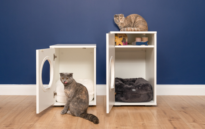Two cats with the maya modern cat house doors open showing the cat house storage